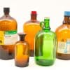 Vintage amber laboratory bottles ideal for decor, collection, or chemical storage in a professional setting.