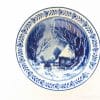 Elegant blue-and-white ceramic plate depicting a serene winter landscape and floral border design.