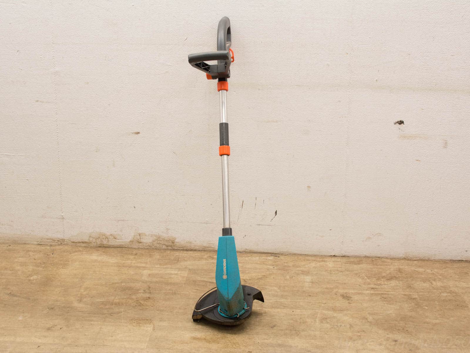 Ergonomic teal blue string trimmer for efficient garden maintenance in hard-to-reach areas.