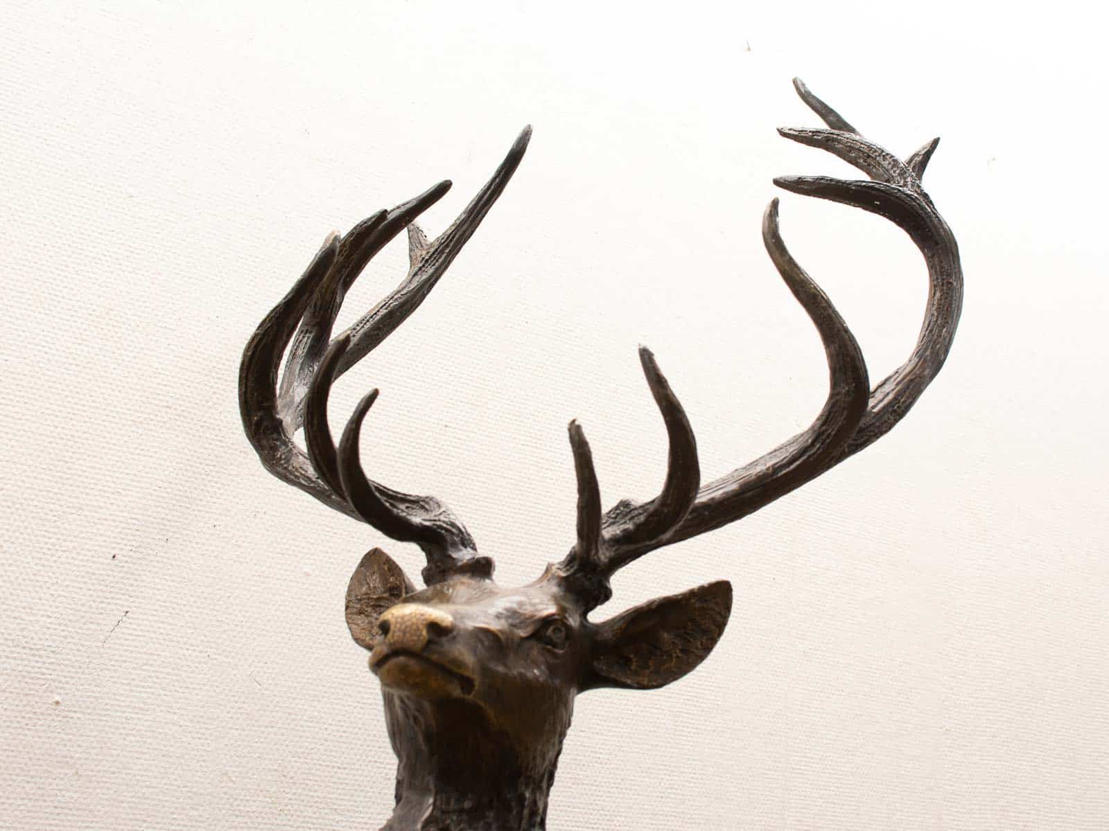 Stunning bronze deer sculpture featuring majestic antlers, showcasing natures elegance and artistry.