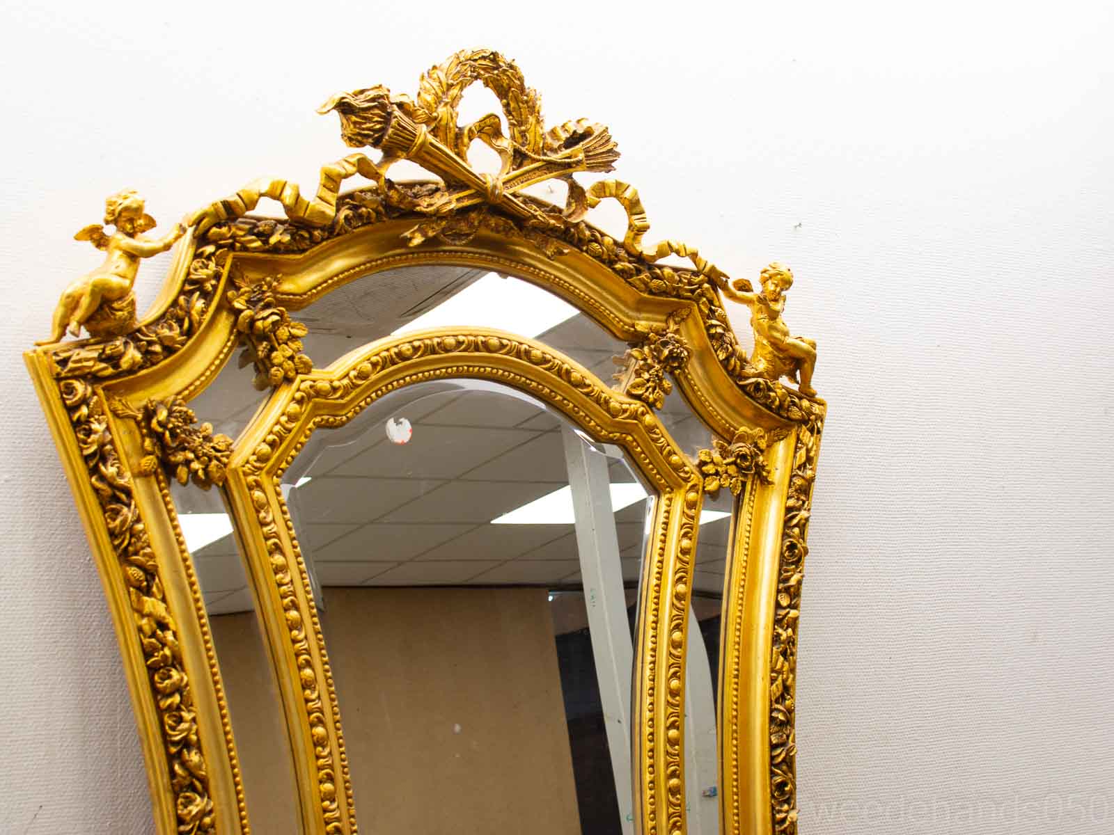 Ornate gilded baroque mirror with cherubs, a stunning centerpiece for any elegant interior.