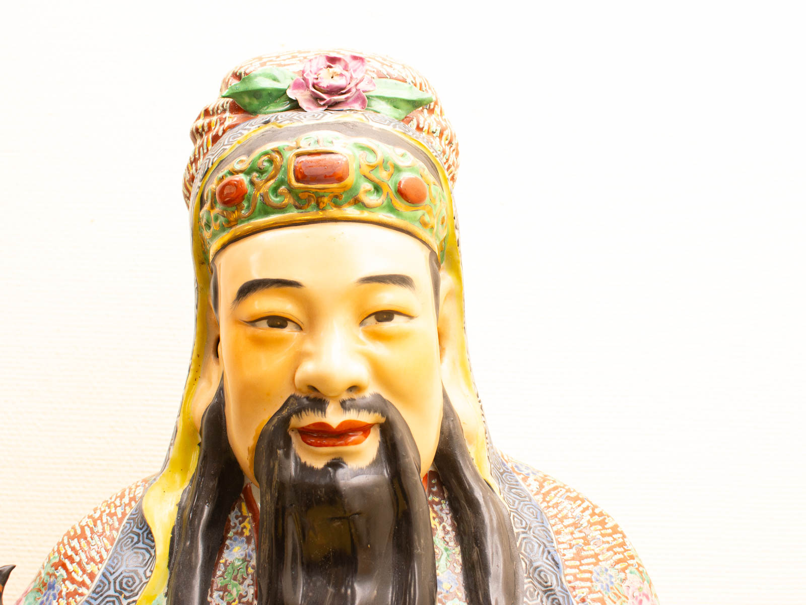 Colorful Chinese statue with intricate headdress and robes, showcasing artistic and cultural heritage.