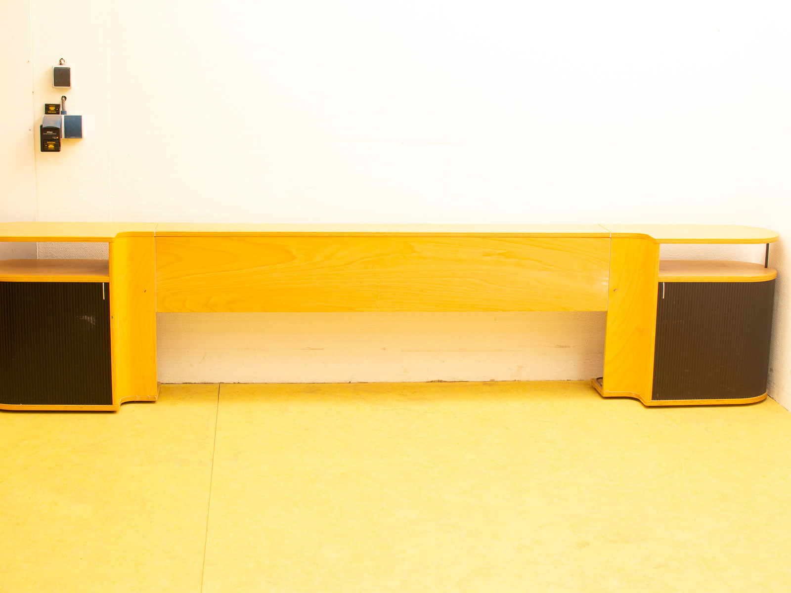 Sleek wooden shelf with black cabinets, perfect for modern living rooms or offices.