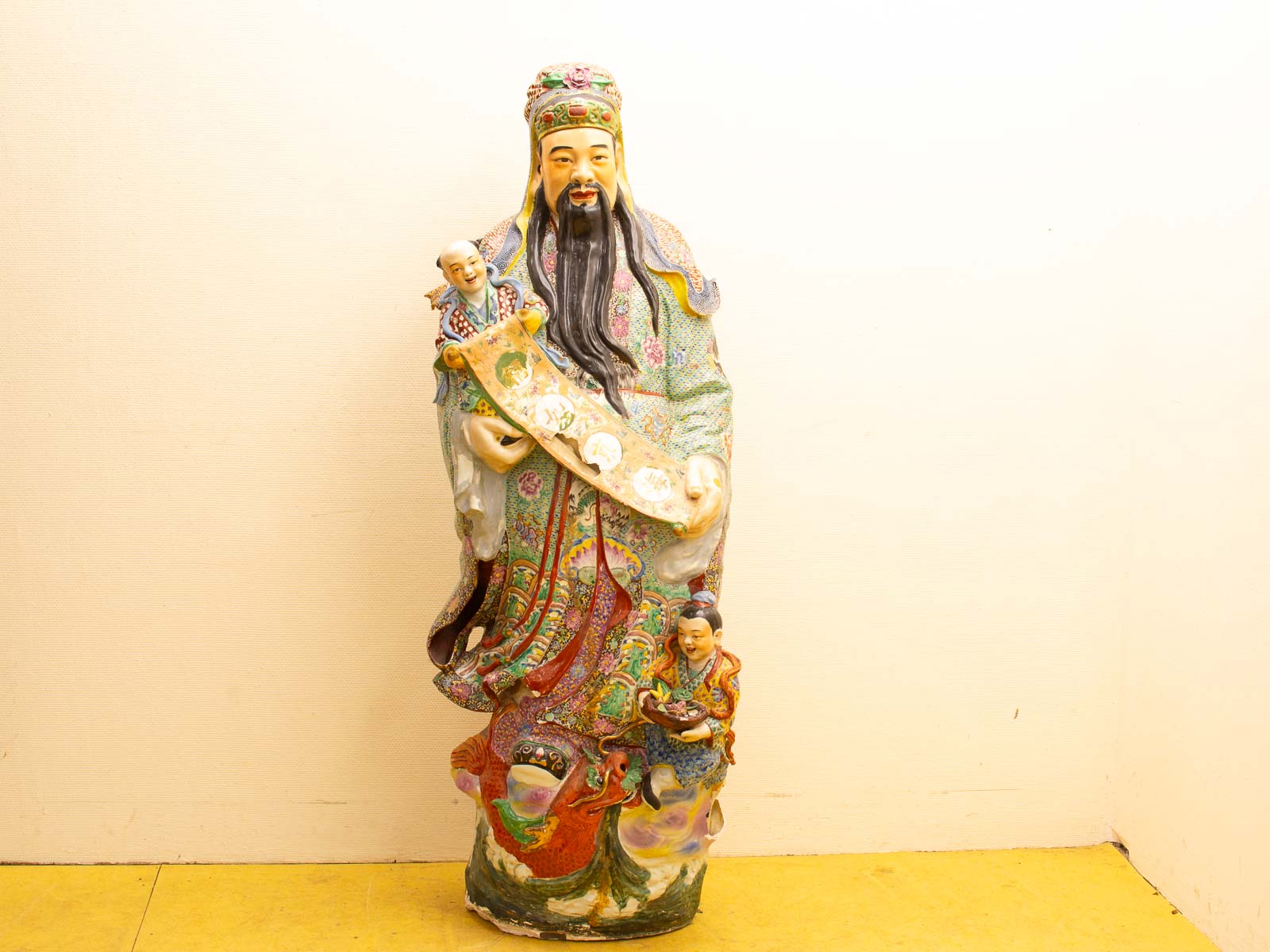 Traditional Chinese ceramic statue showcasing prosperity, adorned with vibrant colors and joyful child figures.