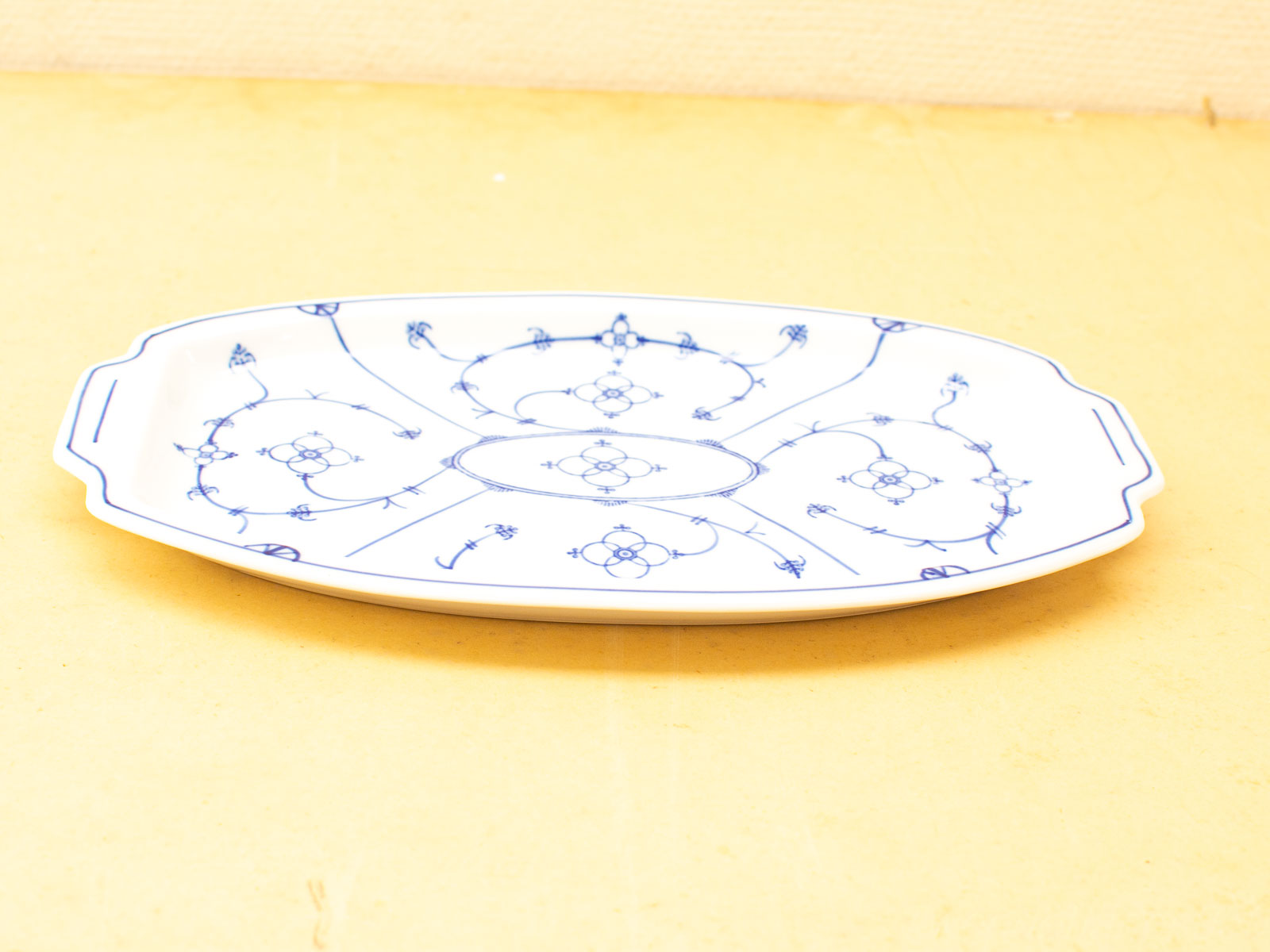 Elegant porcelain serving platter with intricate blue floral patterns, ideal for formal dining.