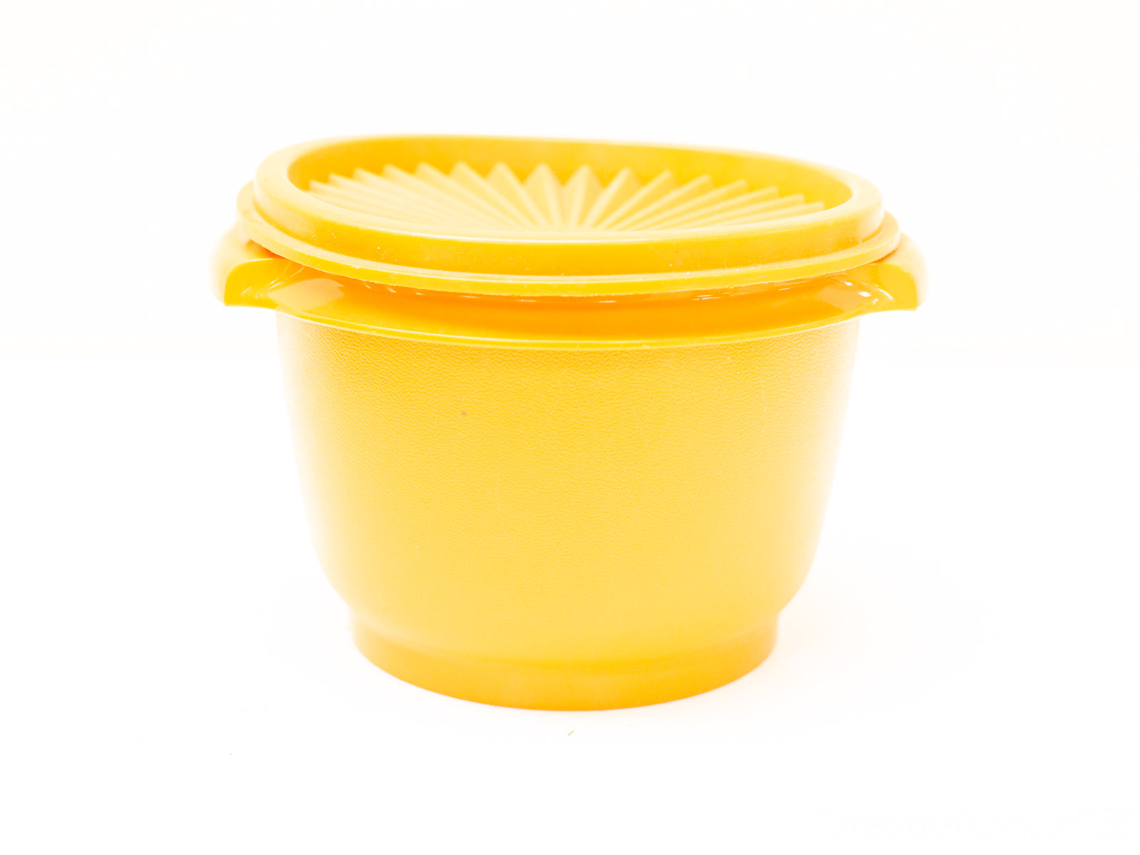 Cheerful yellow kitchen storage container with lid, perfect for organizing and storing leftovers.