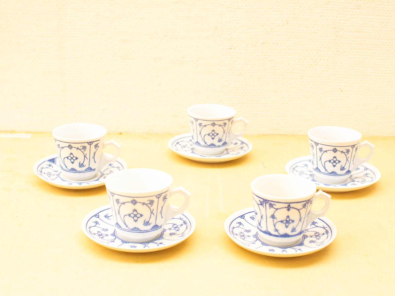 Charming vintage porcelain teacup and saucer set with intricate blue floral designs. Perfect for tea time.