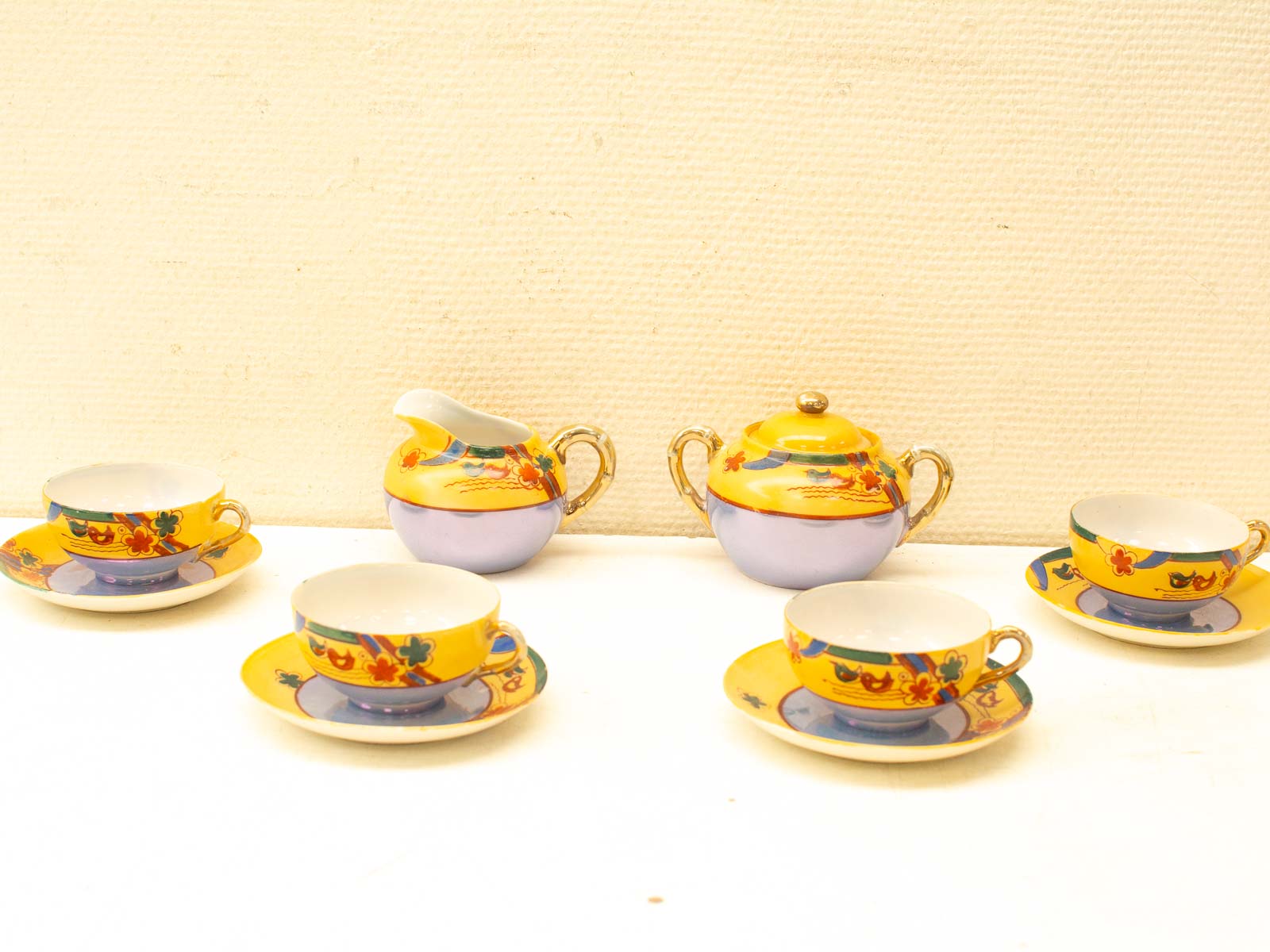 Vintage floral tea set in vibrant yellow, perfect for gatherings or as decorative display.