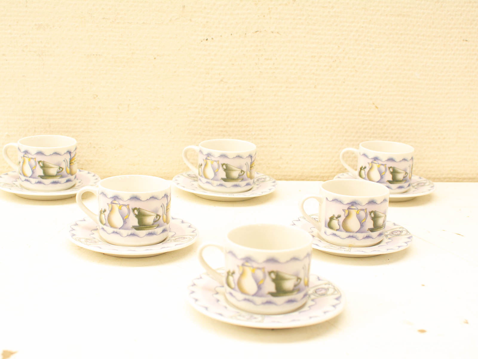 Charming vintage teacup set with whimsical teapot designs for elegant tea gatherings.