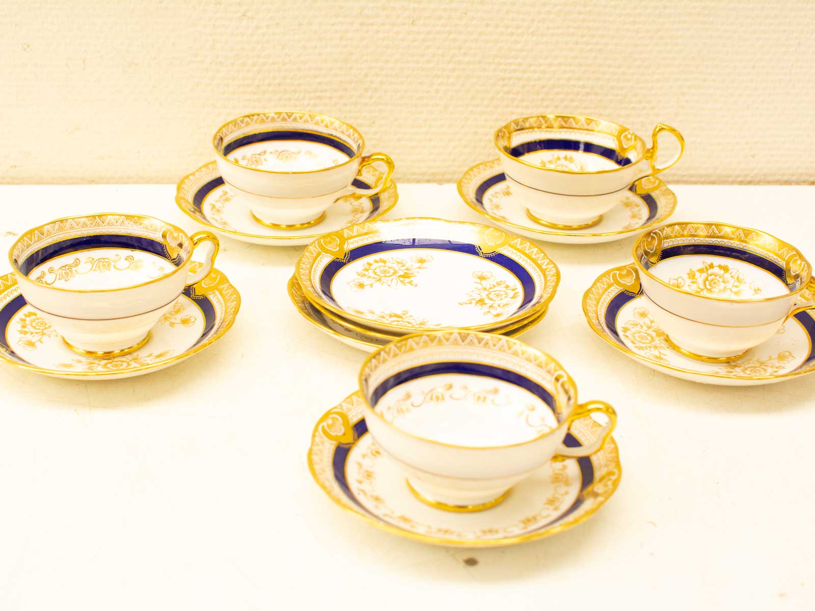 Elegant vintage porcelain tea set with gold detailing, perfect for formal occasions and gatherings.