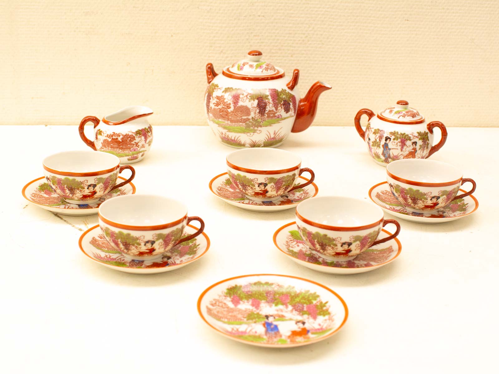 Elegant vintage tea set with vibrant floral patterns, perfect for tea gatherings and decor.