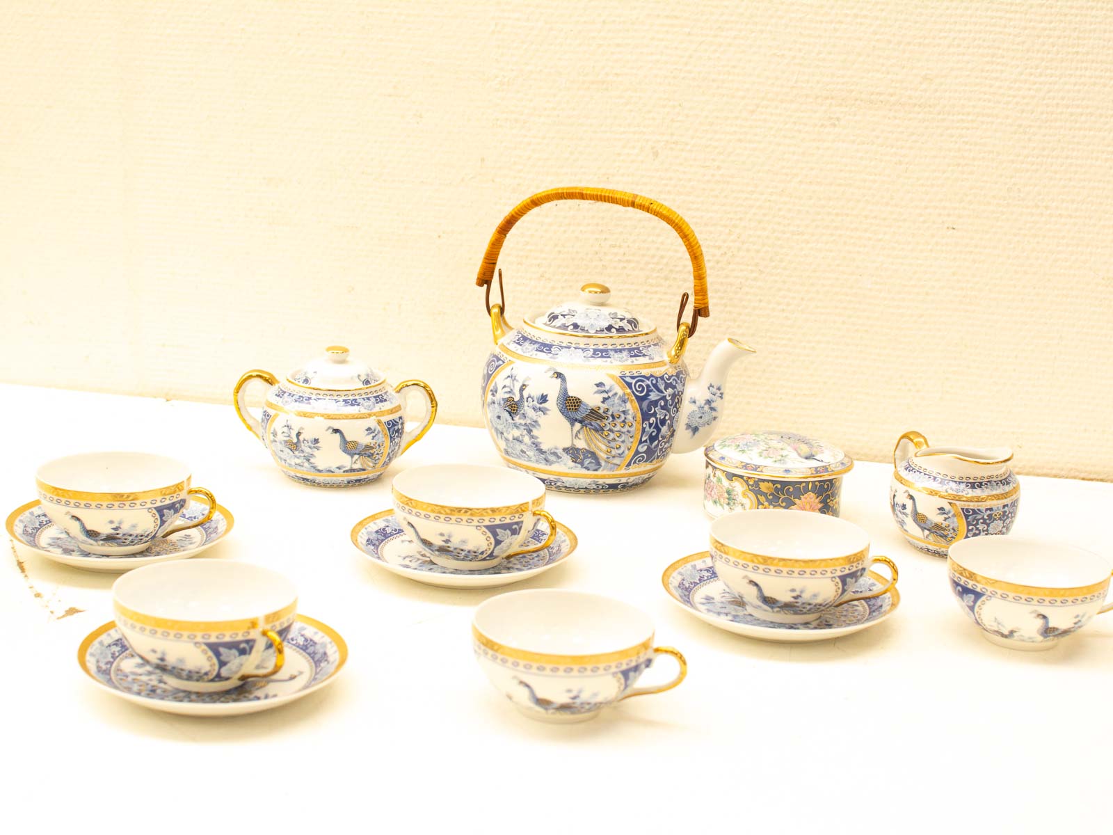 Elegant blue and white porcelain tea set with gold accents, perfect for collectors and tea lovers.