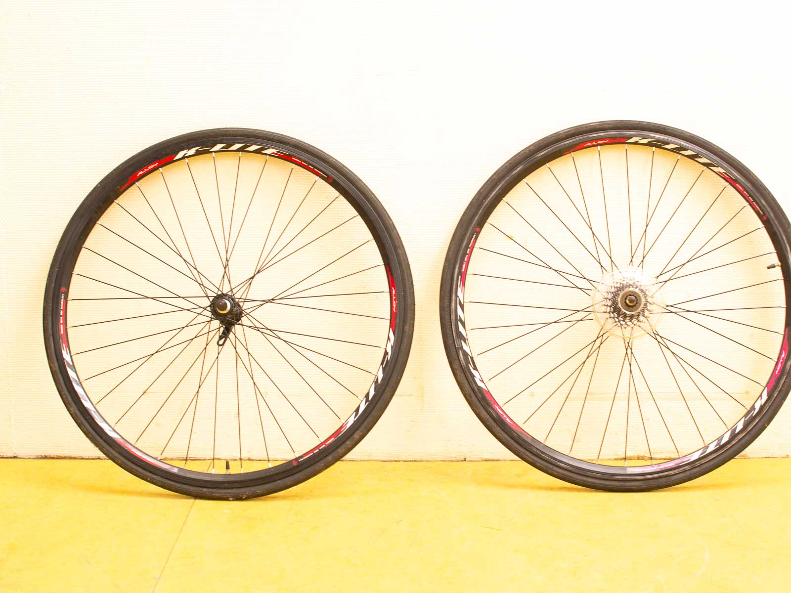 Sleek black and red bicycle wheels for speed and efficiency in cycling performance.