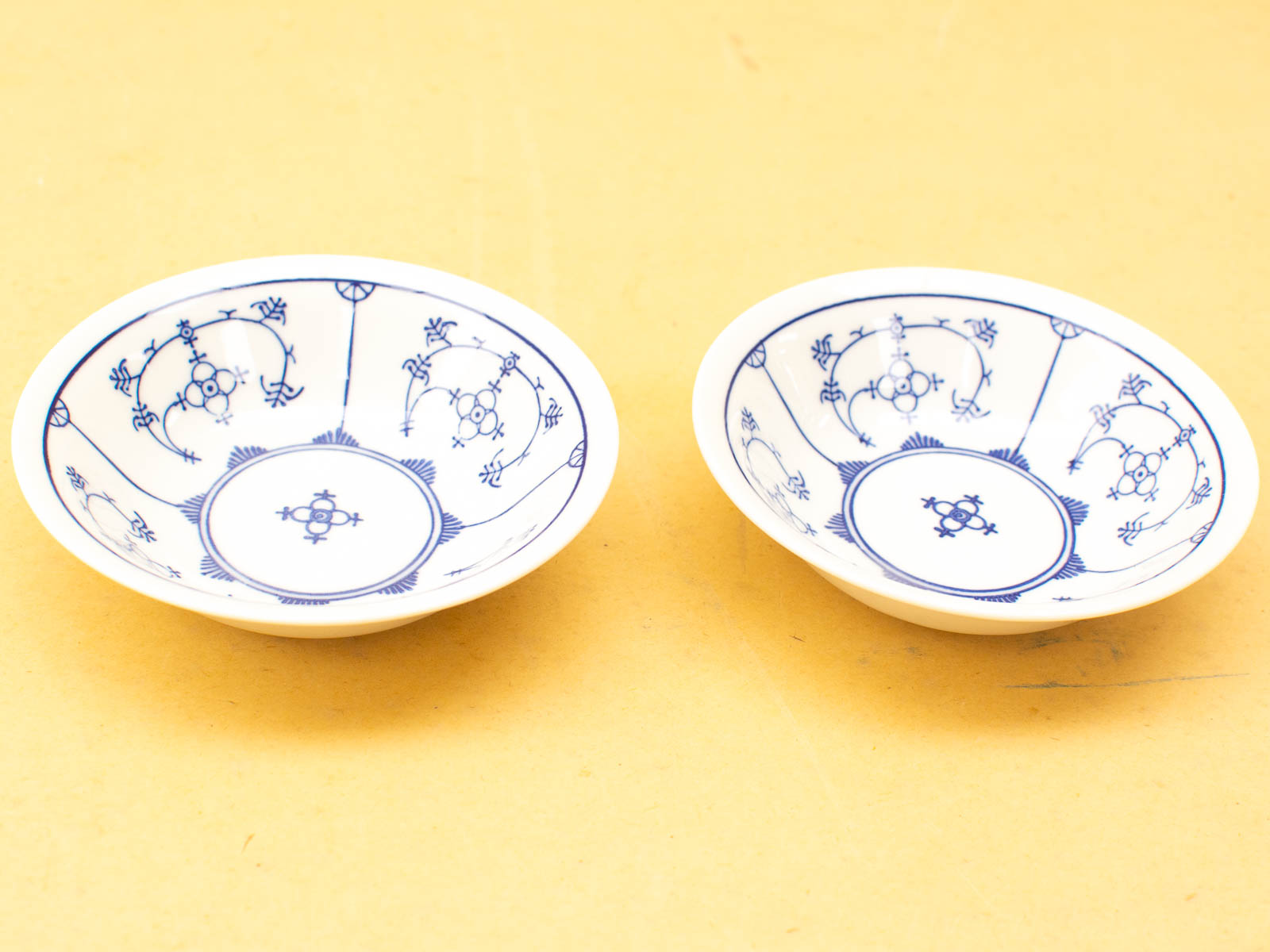 Elegant vintage porcelain bowls with intricate blue designs on white, perfect for display or serving.