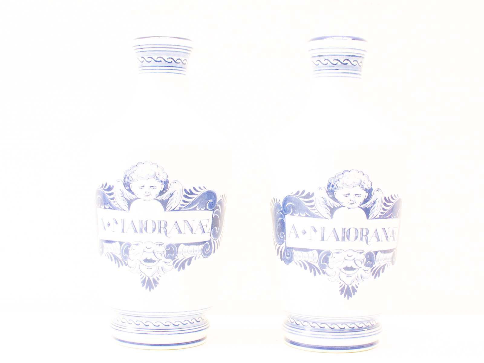 Elegant blue and white ceramic vases with cherub motifs, perfect for stylish decor.