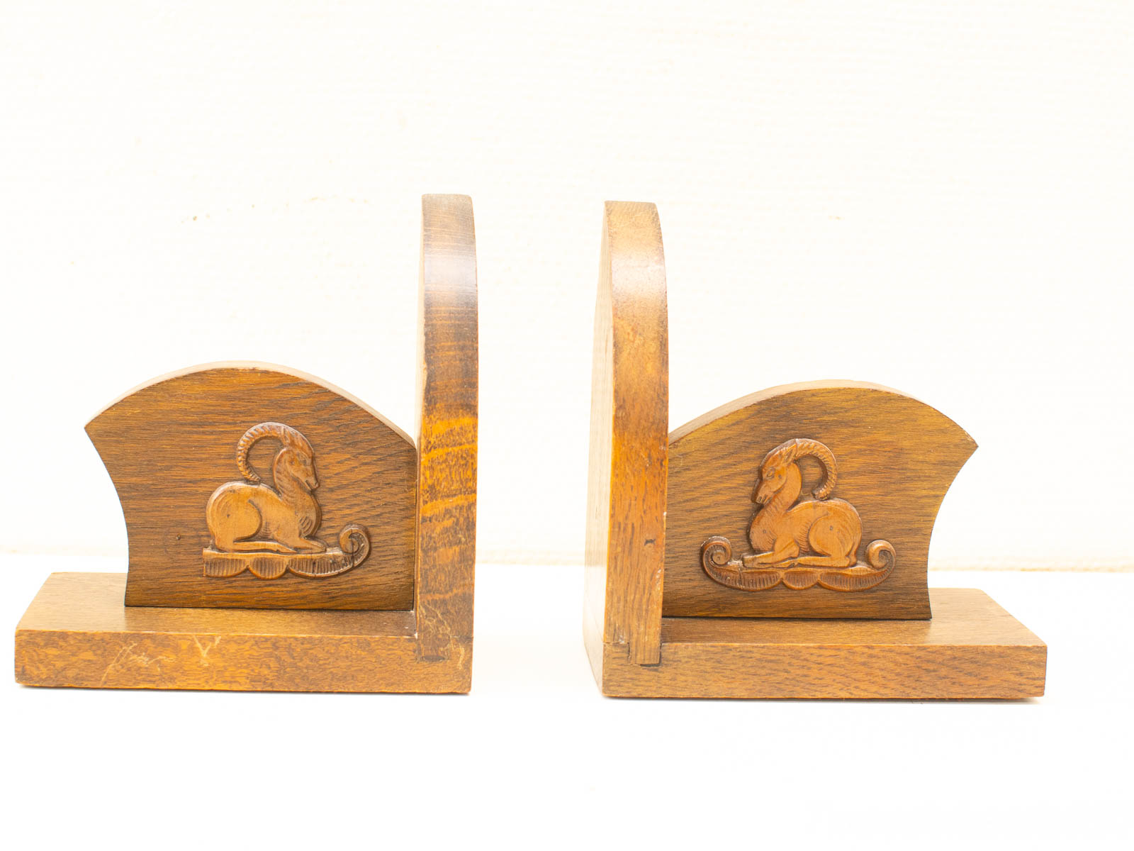 Charming vintage wooden bookends with detailed ram carvings, perfect for decor or book organization.