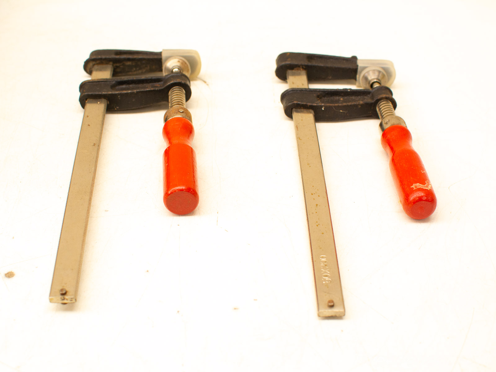 Vintage bar clamps with ergonomic handles for woodworking and metalworking projects. Reliable and functional.