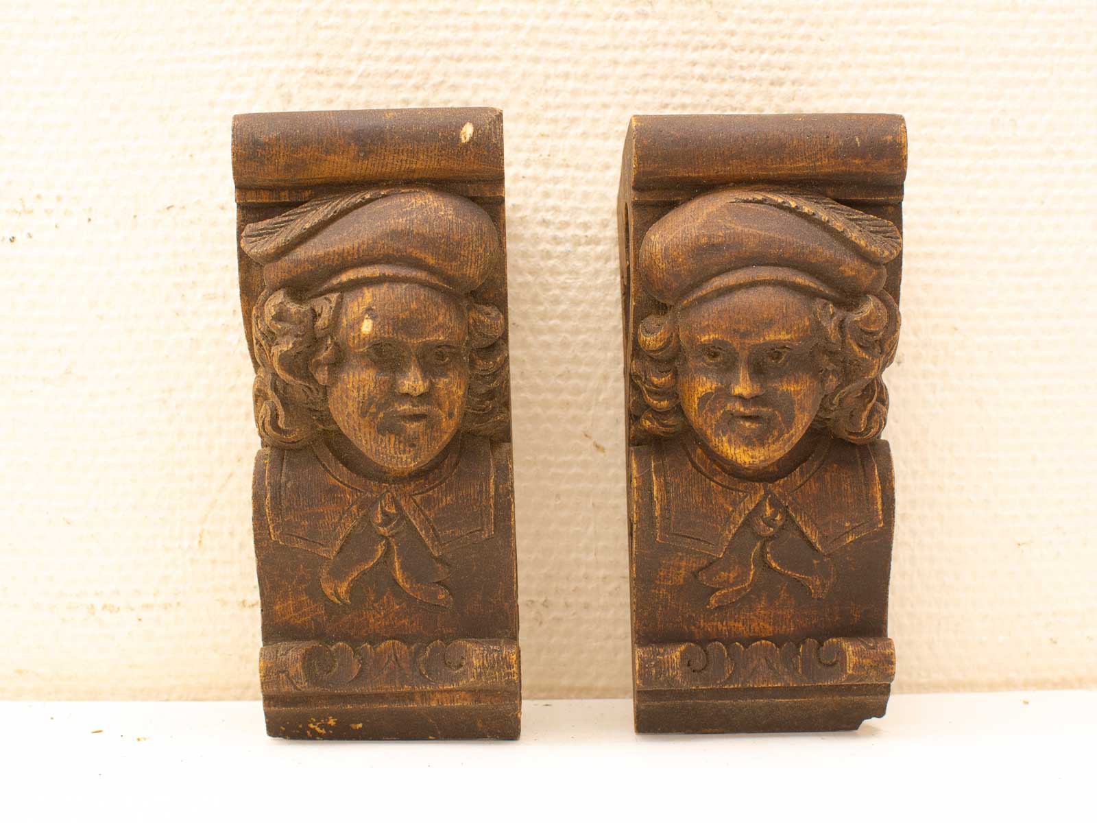 Intricate wooden faces with rich detail and historical charm, showcasing skilled craftsmanship and storytelling.