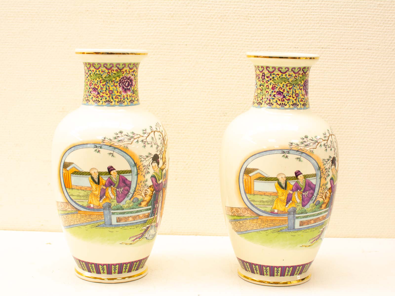 Elegant vintage Asian vases with intricate patterns and vibrant scenes, perfect for home decor.