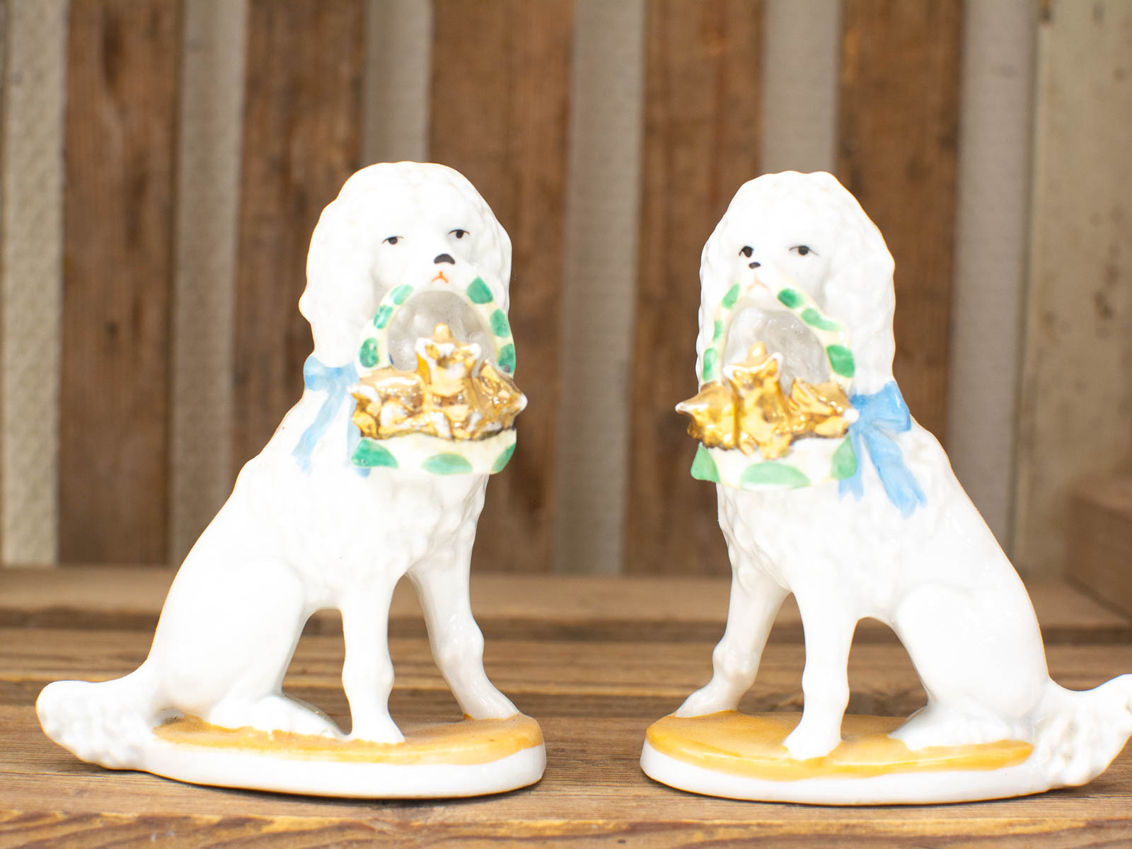 Elegant porcelain dog figurines with ribbons and golden treasures, perfect for collectors and decor.