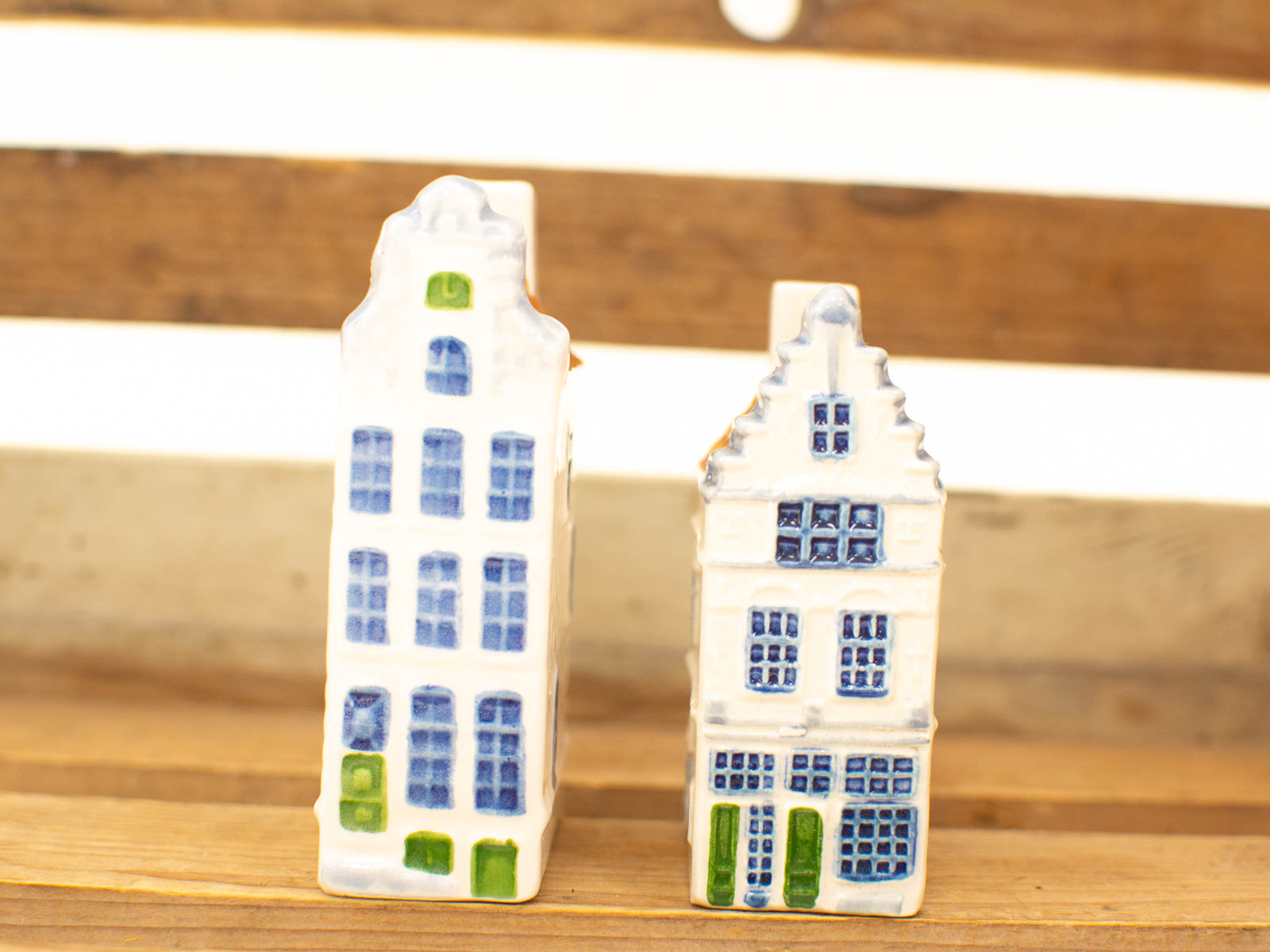 Whimsical ceramic Dutch buildings with vibrant blue and green accents for delightful home decor.