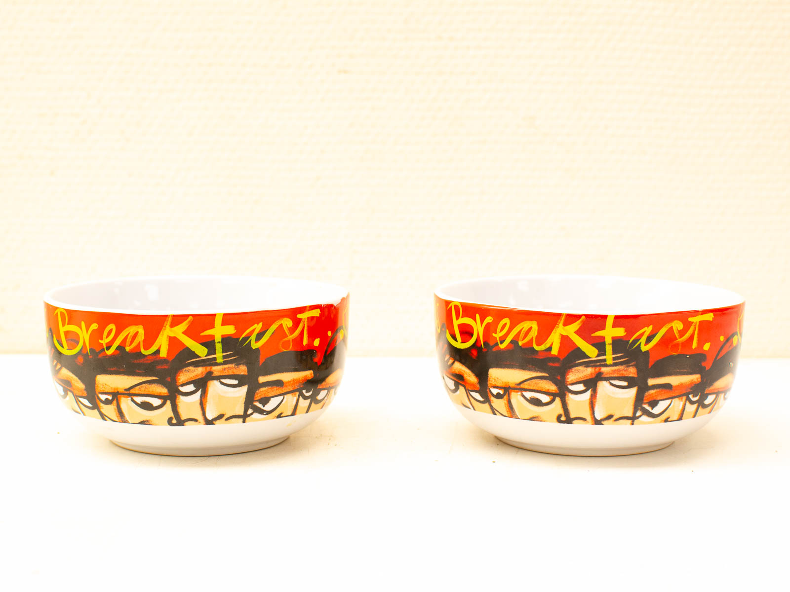 Cheerful vintage breakfast bowls with stylized faces and glossy red finish for morning meals.