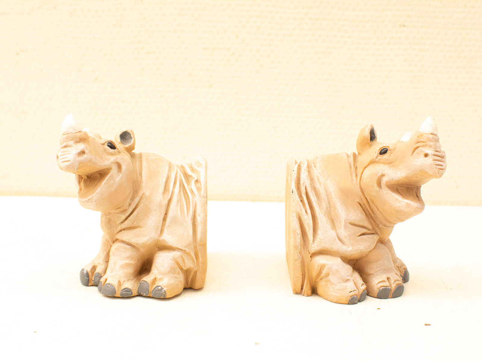 Charming ceramic rhinoceros figurines with playful expressions, perfect for vintage home decor.