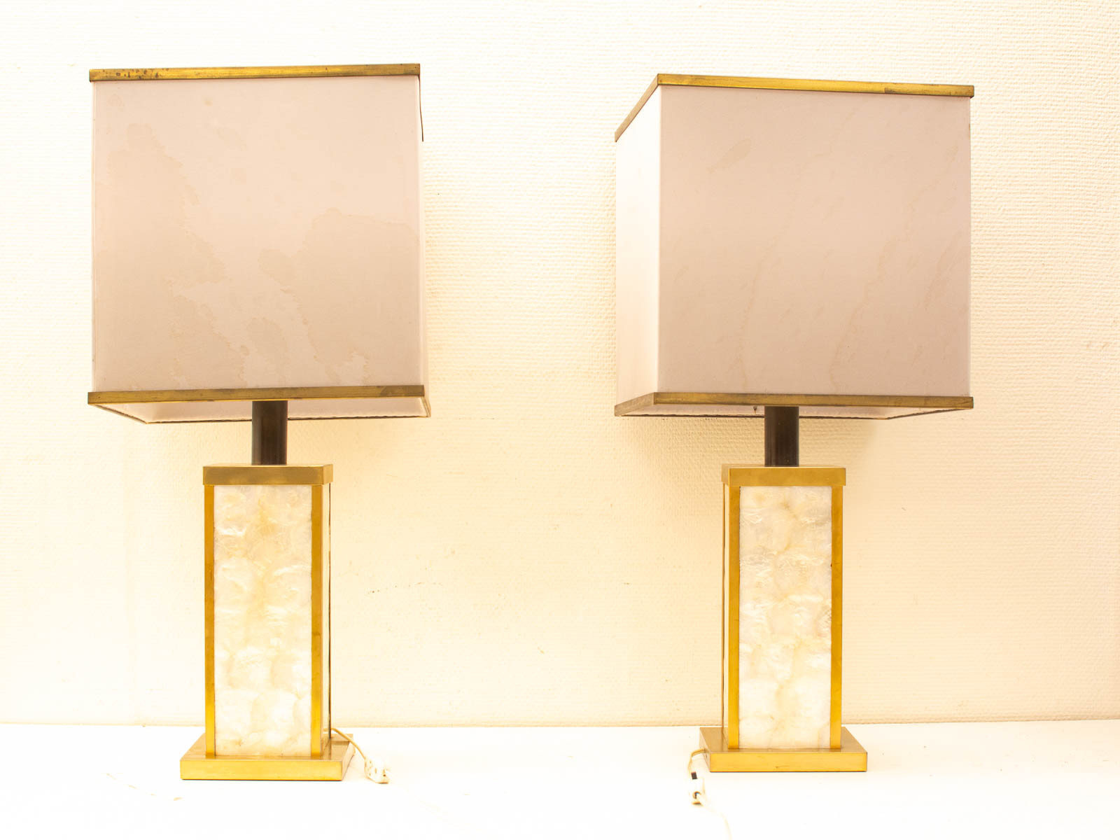 Elegant vintage table lamps with gold accents and alabaster bases for a warm, sophisticated atmosphere.