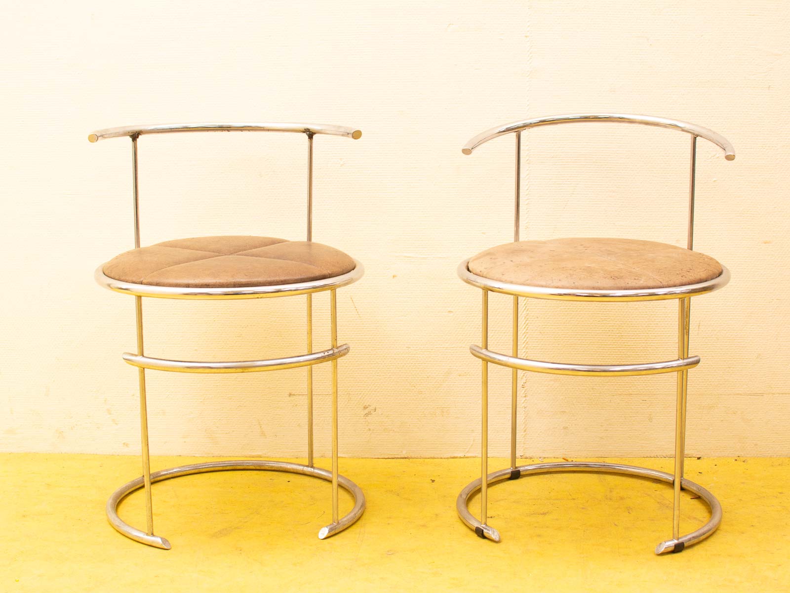 Modern bar stools with light brown upholstery and chrome frames for a sleek, stylish look.