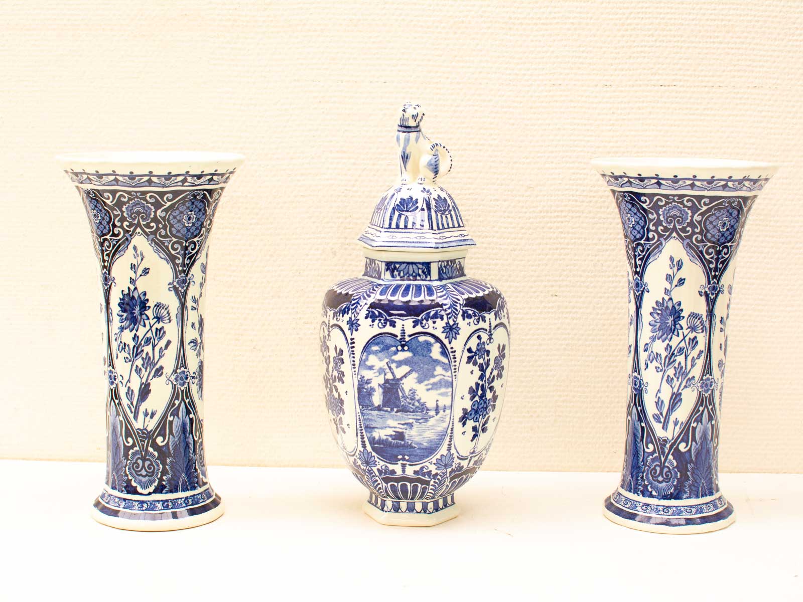 Elegant blue and white vintage ceramic vases with intricate designs and serene landscapes.