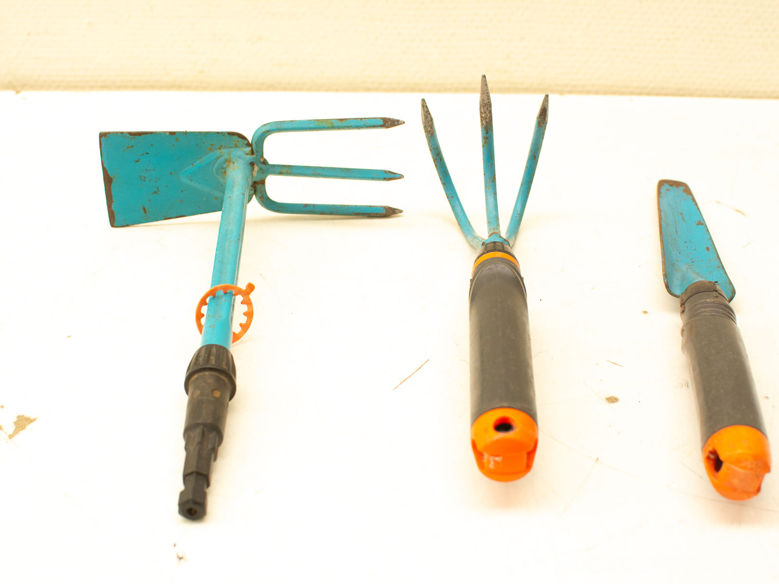 Vintage gardening tools set with blue handles, perfect for enhancing your gardening experience.