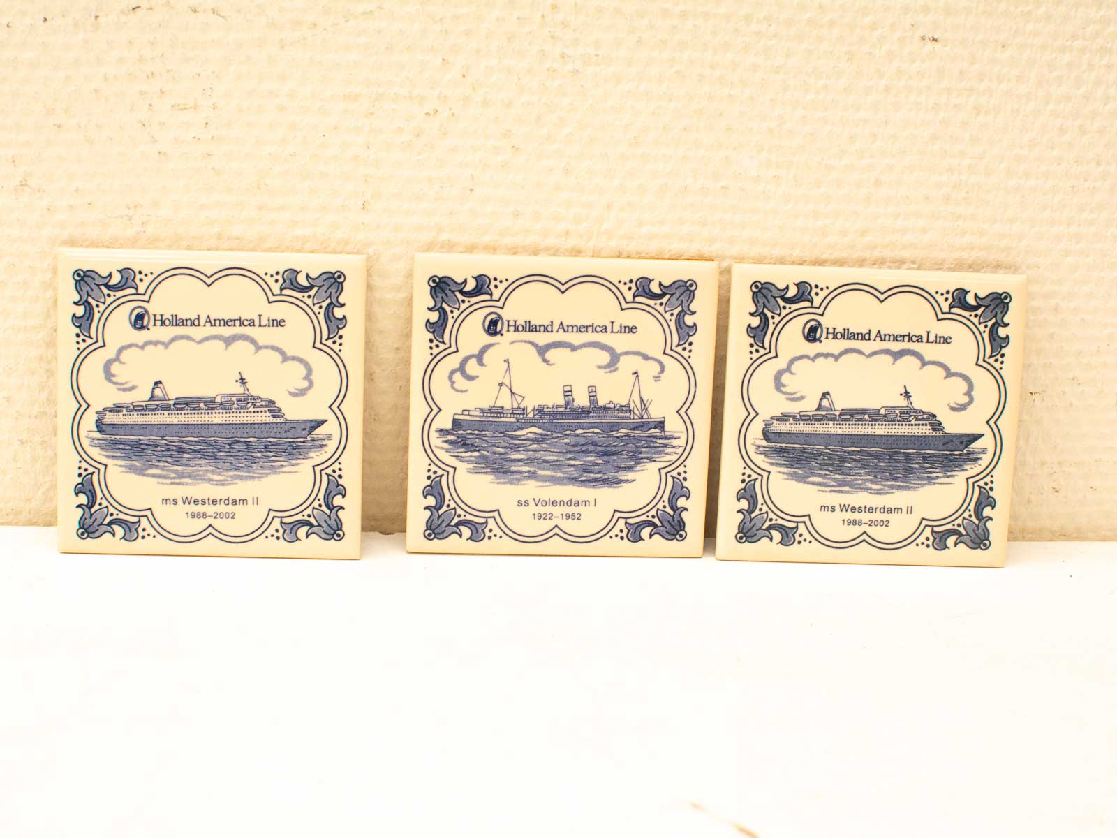 Holland America Line vintage tiles showcasing iconic cruise ships in elegant blue and white designs.