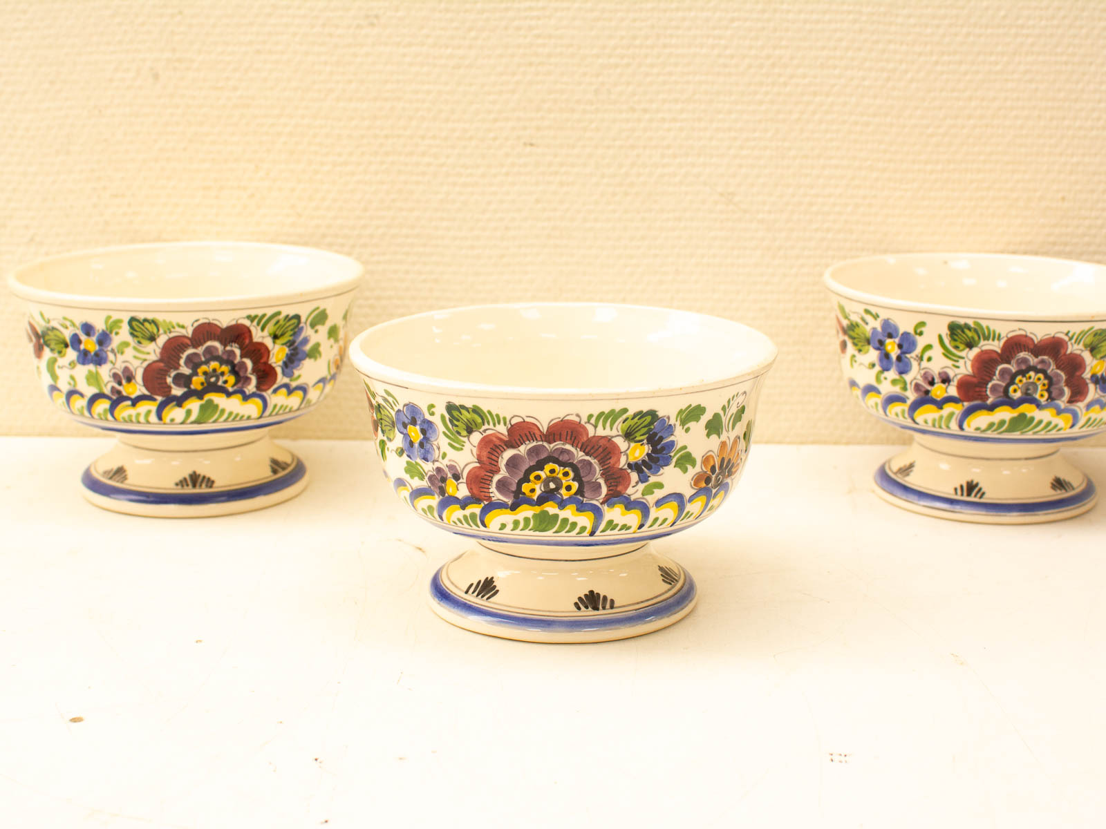 Elegant hand-painted bowls with vibrant floral designs, perfect for serving or display in any setting.