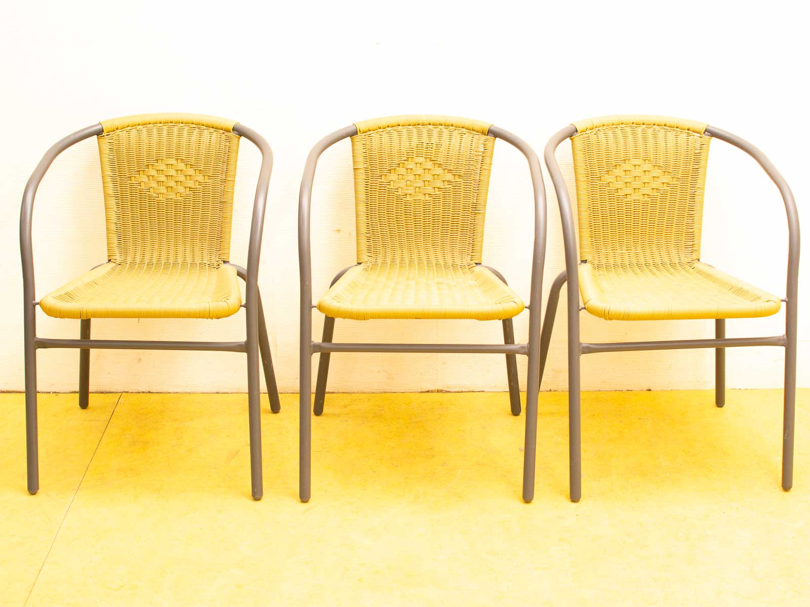 Stylish yellow woven chairs with gray frames for home and garden gatherings.