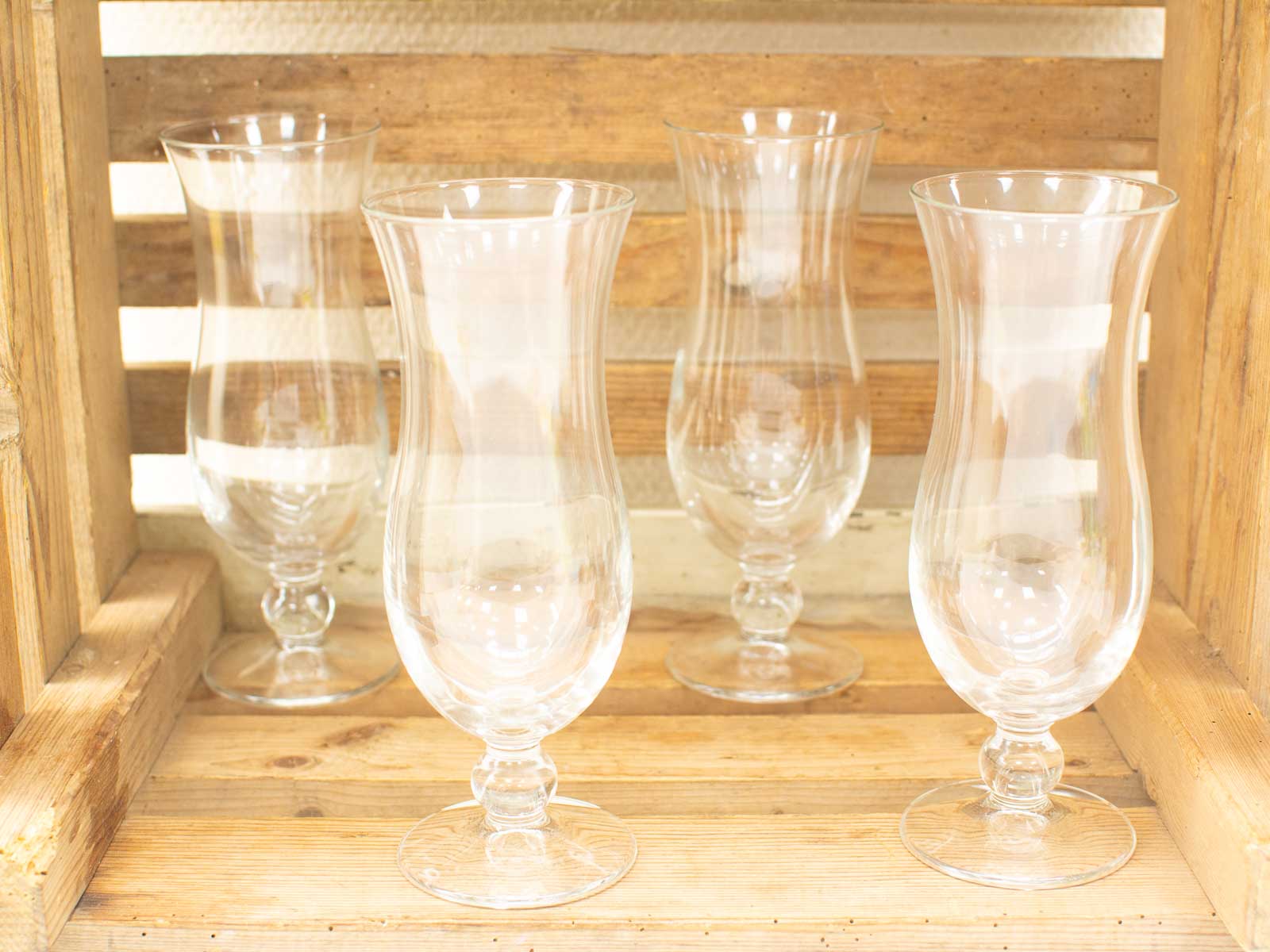 Elegant glassware in a rustic wooden crate, perfect for vintage collections and stylish gatherings.