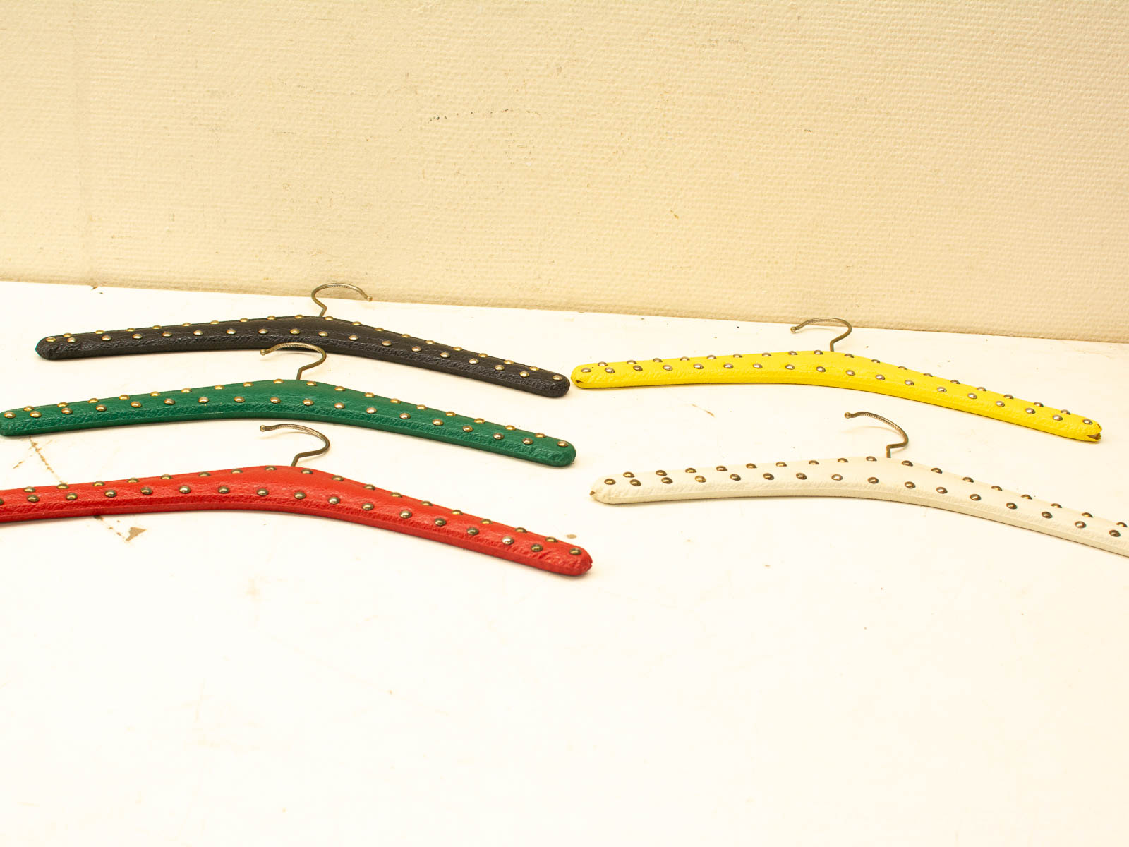 Colorful vintage hangers with studs, perfect for stylish organization and home decor.