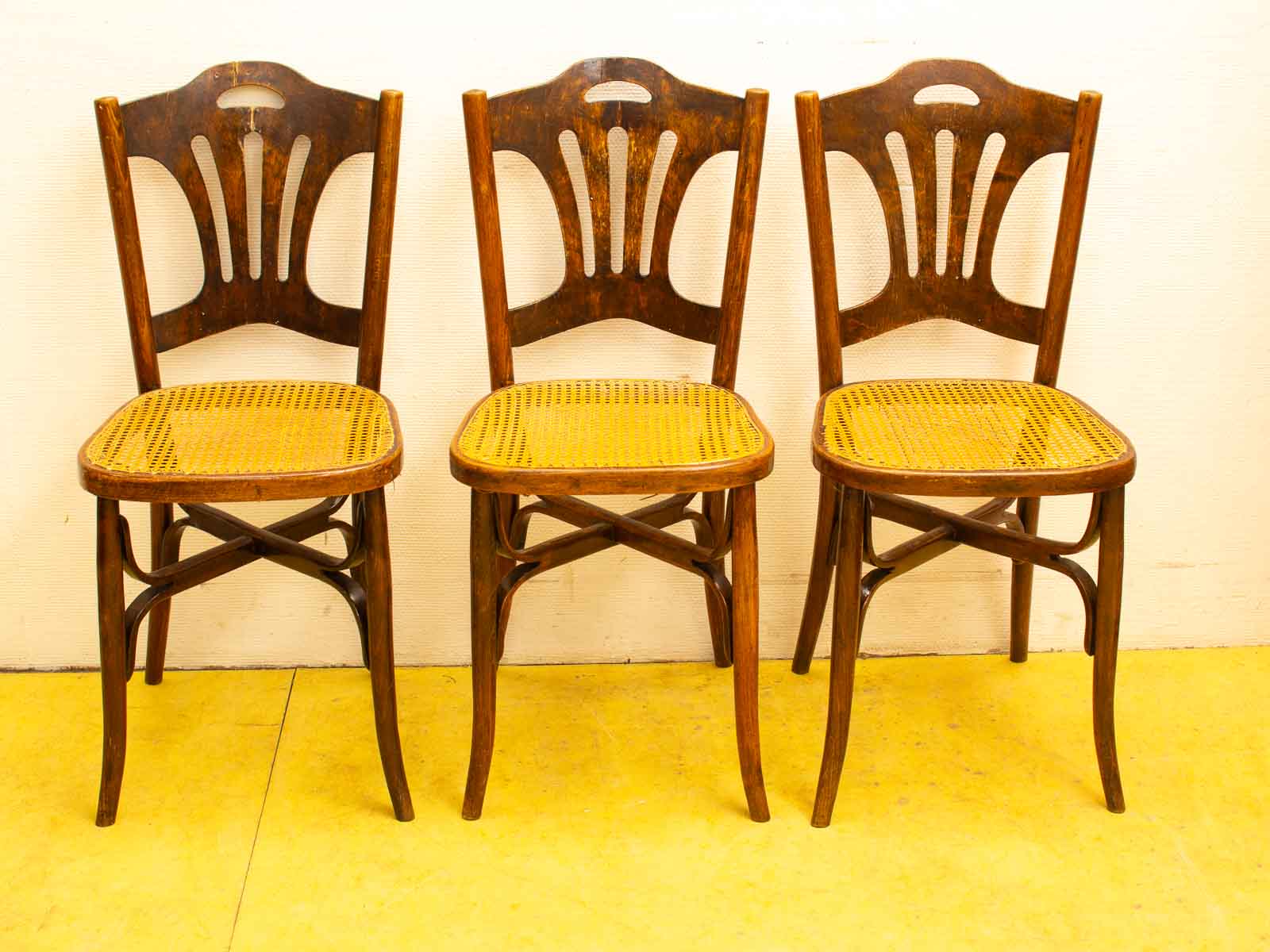 Elegant vintage wooden chairs with woven cane seats, perfect for any stylish setting.