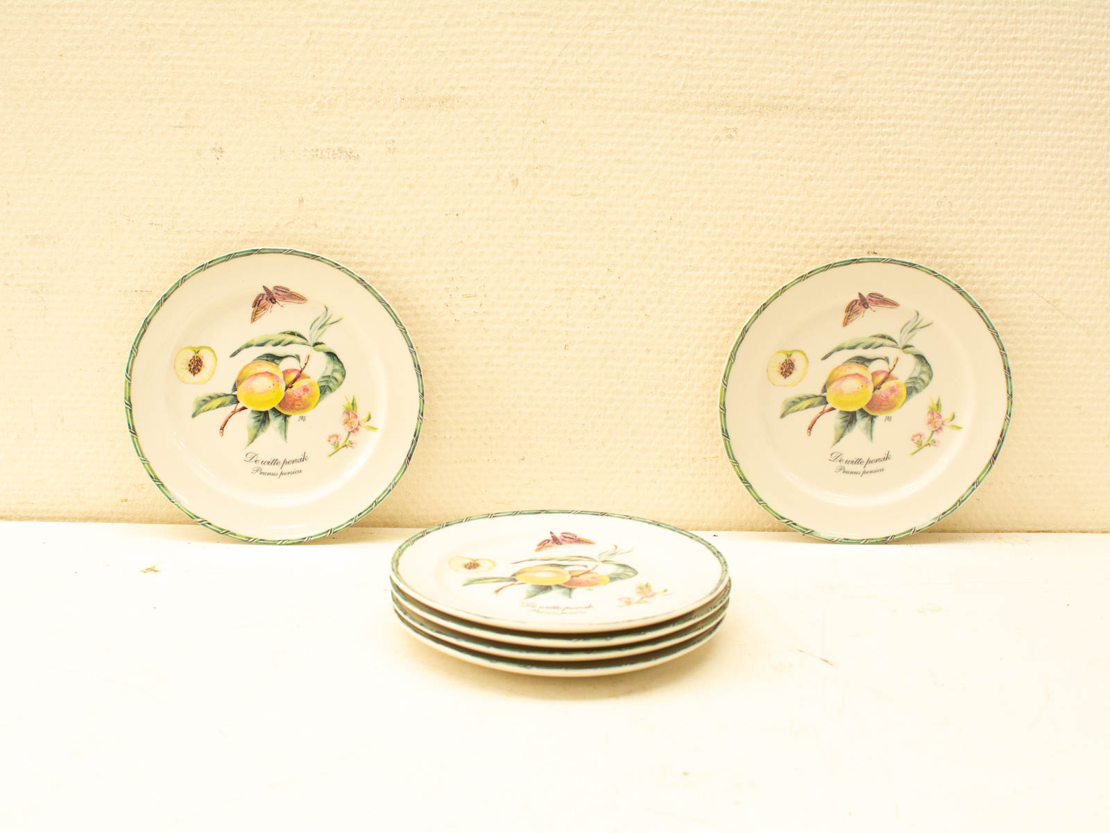 Charming vintage decorative plates featuring peach and floral designs for elegant display.