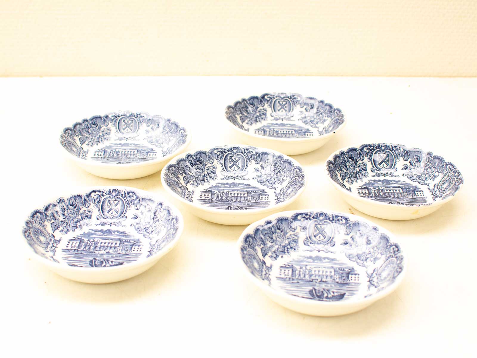 Elegant blue and white decorative plates featuring scenic landscapes and intricate designs.