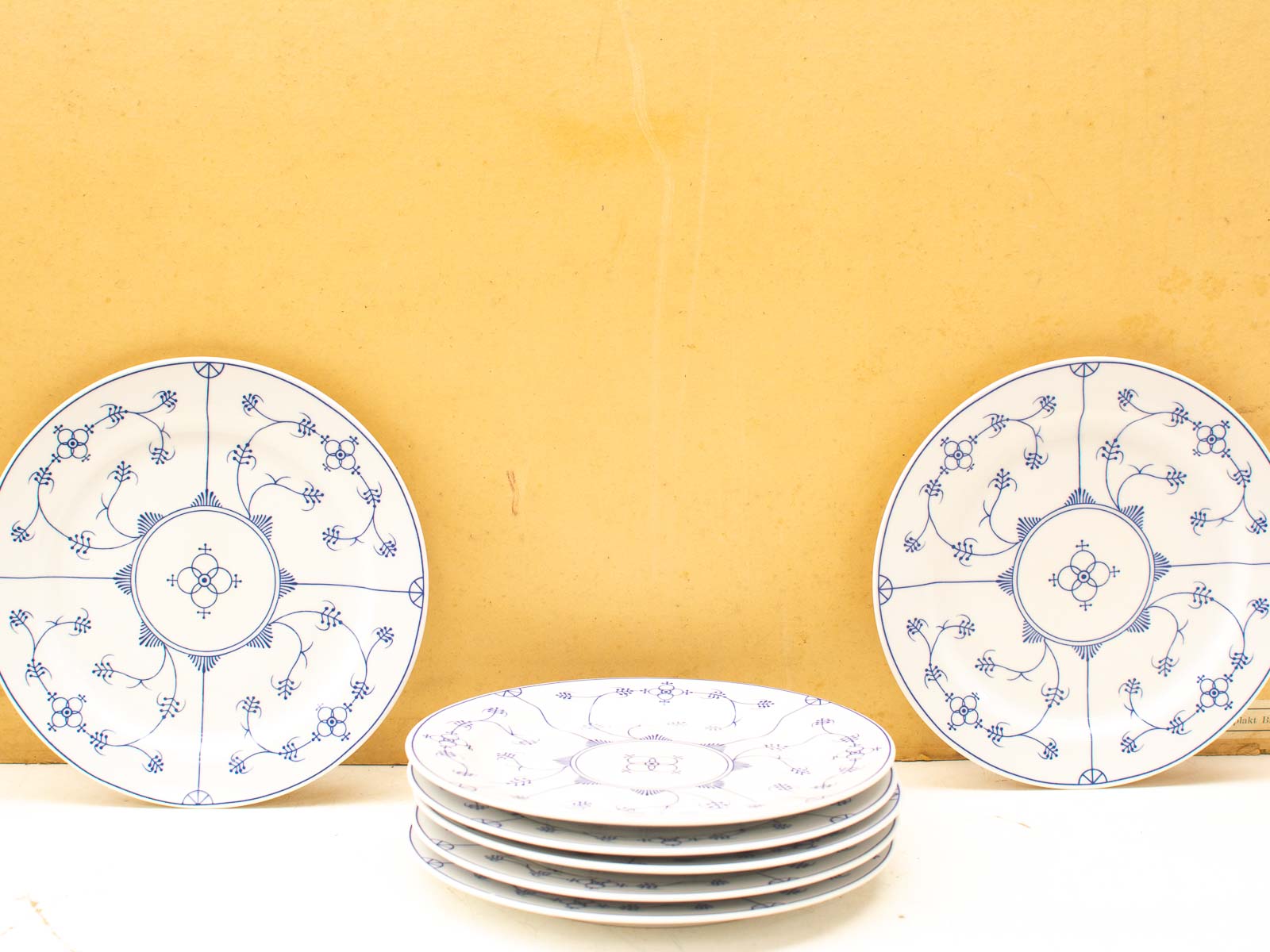 Elegant white plates with blue patterns for vintage-inspired dining settings.