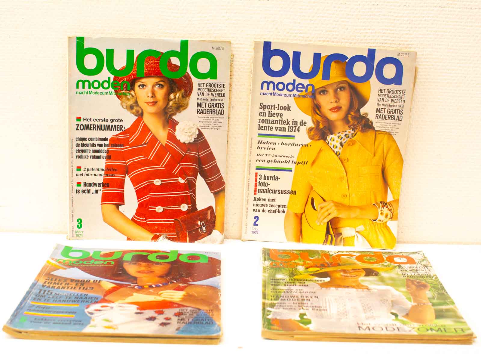 Vintage Burda Moden magazines from 1974 showcasing vibrant fashion and sewing patterns for DIY enthusiasts.