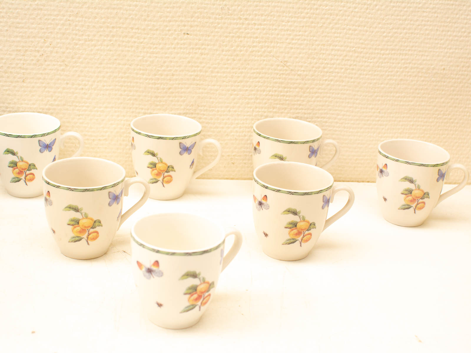 Charming ceramic cup set with floral and butterfly designs, perfect for tea parties and coffee breaks.