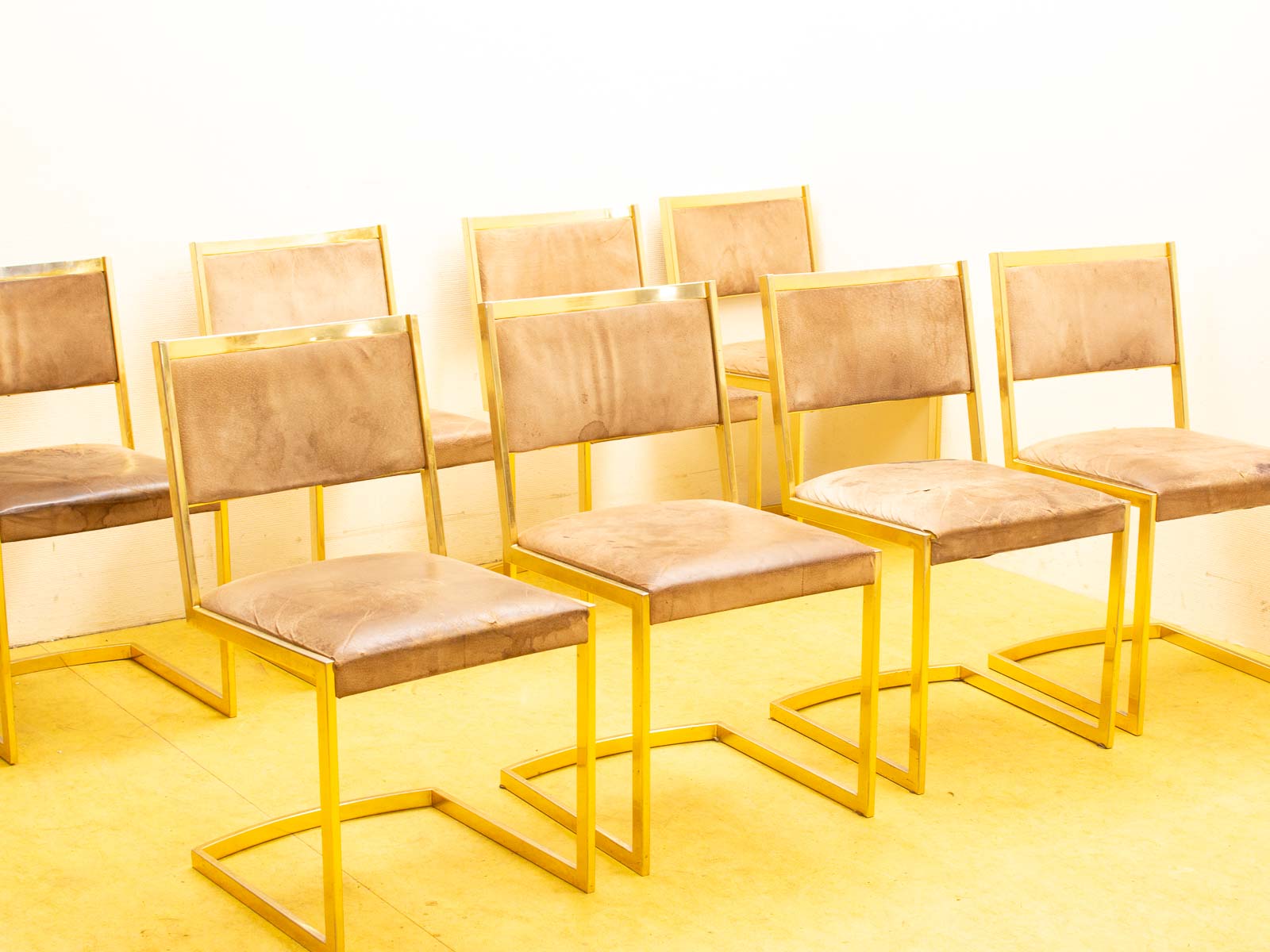 Chic modern leather chairs with gold frames, perfect for stylish and inviting spaces.