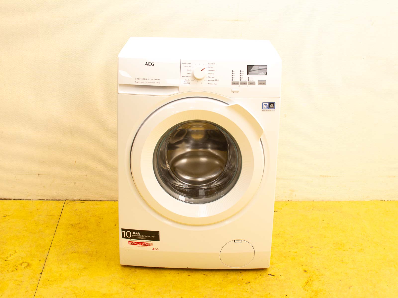 Sleek AEG washing machine with glass door and 10-year warranty for modern laundry spaces.