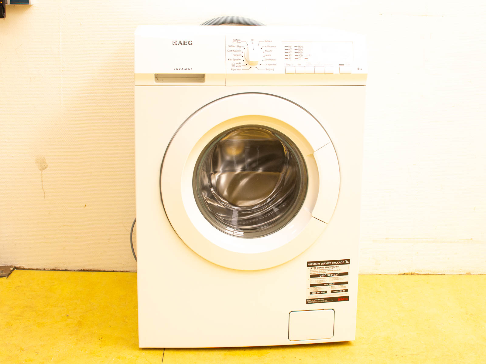 Modern AEG front-loading washing machine with glass door for efficient, customizable laundry solutions.