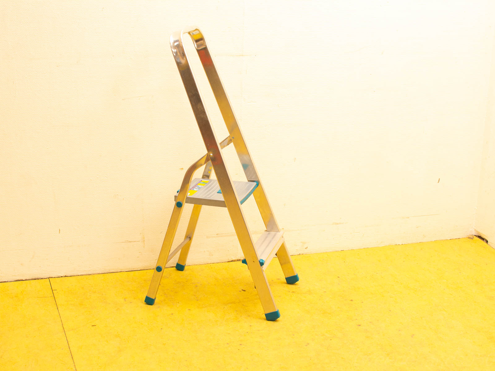 Compact aluminum step ladder with non-slip feet, perfect for safe and easy access to high places.