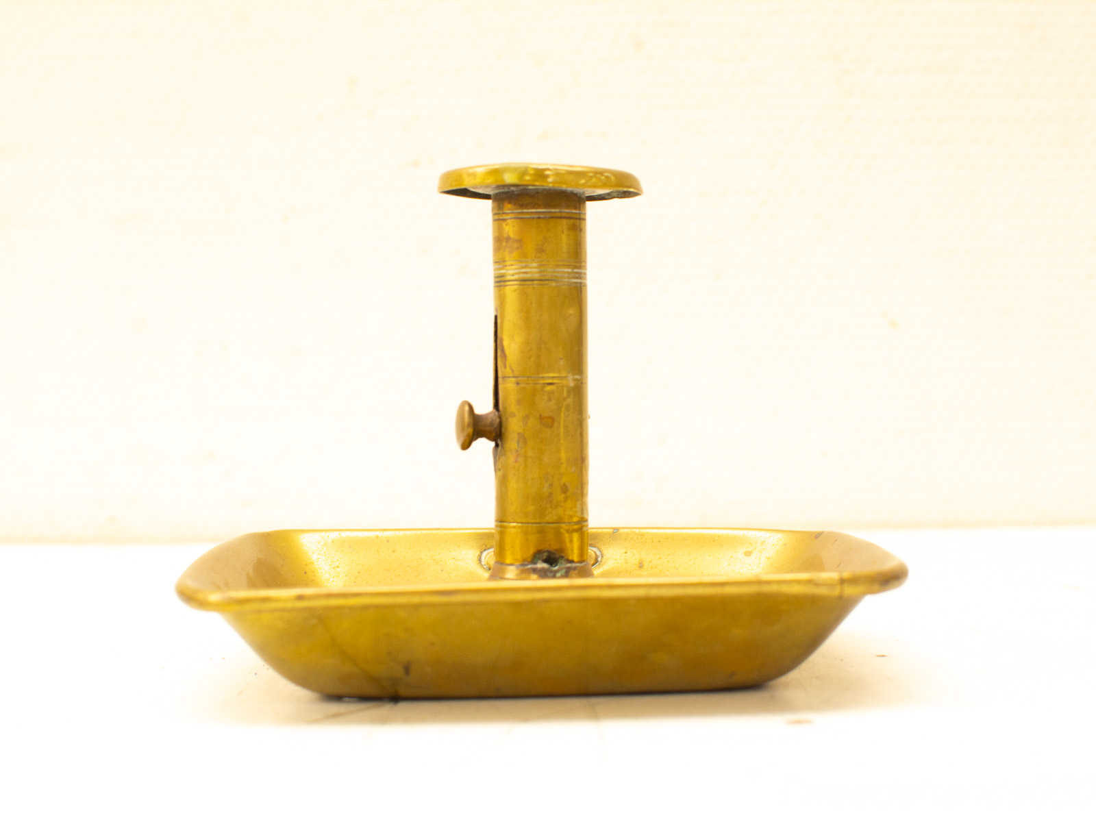 Elegant vintage brass candle holder with tray, adding charm to any decor.