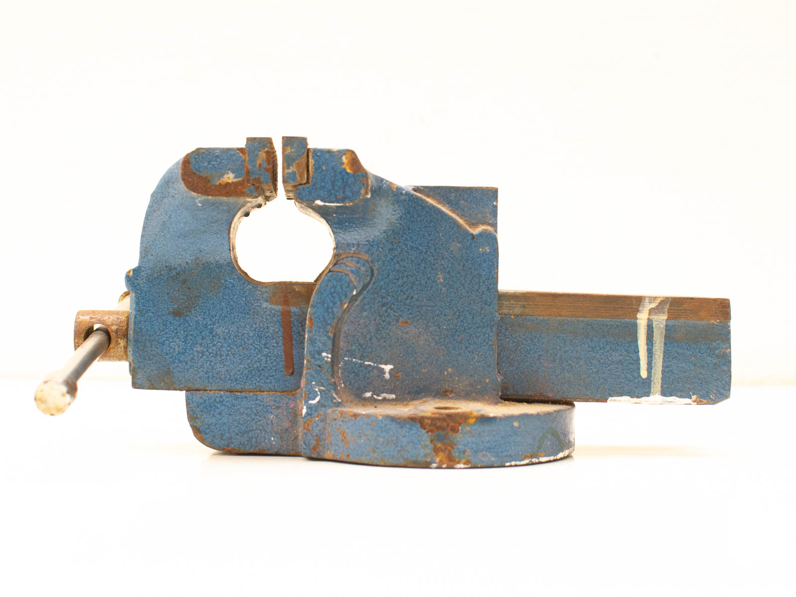 Vintage blue bench vise with rust and wear, showcasing durability and craftsmanship.