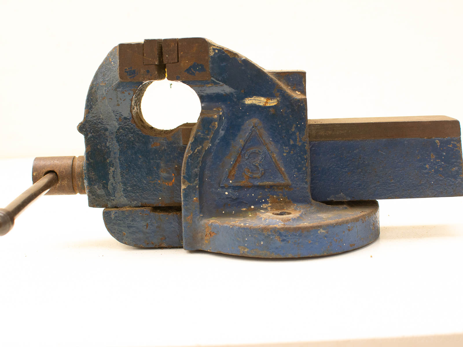 Vintage blue metal vise with wear, ideal for metalworking and woodworking enthusiasts.