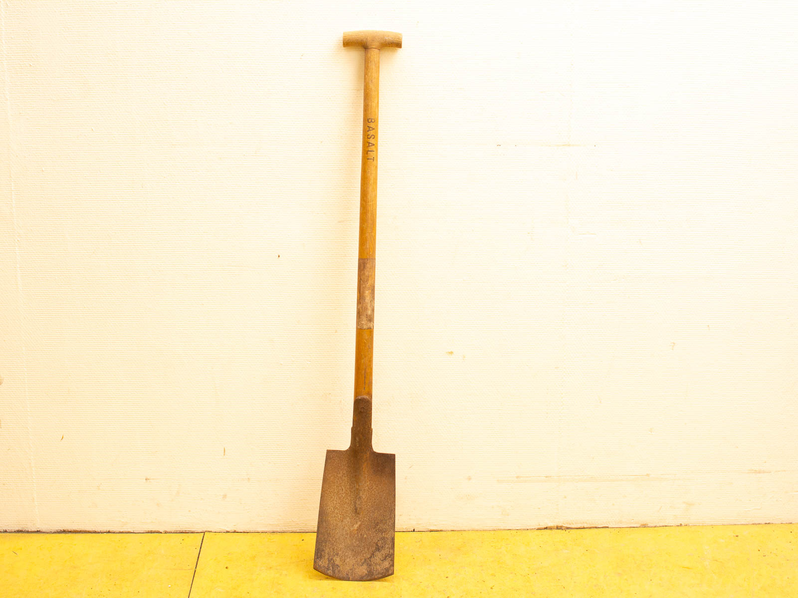 Vintage garden shovel with a polished wooden handle and a durable metal blade for reliable use.